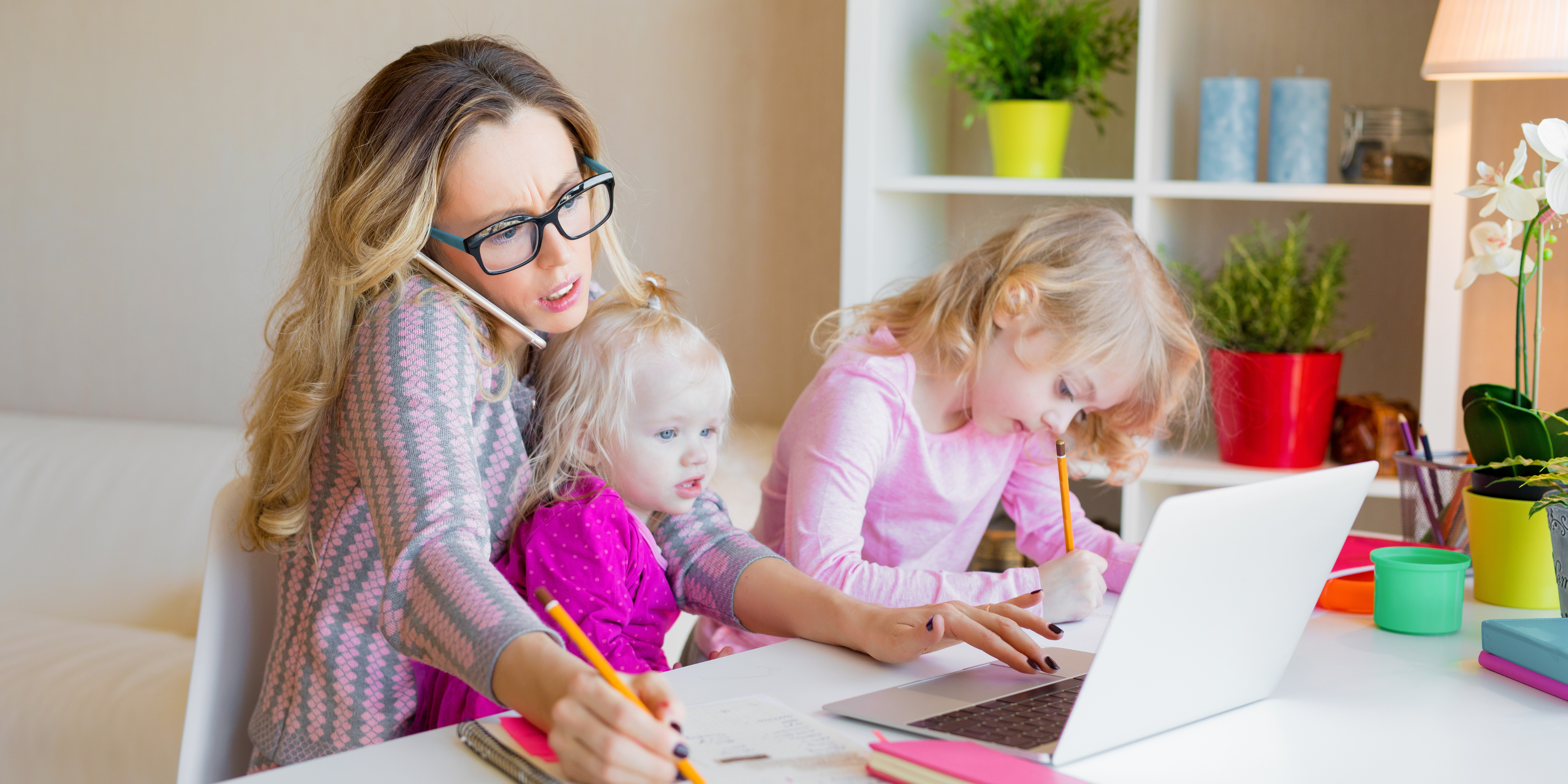 nanny transition to two children at a desk with one coloring and the other in the nanny's lap